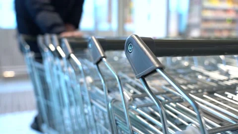 The customer takes a trolley from the row Stock Footage 152473942