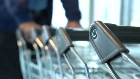The customer takes a trolley from the row Stock Footage 152474115