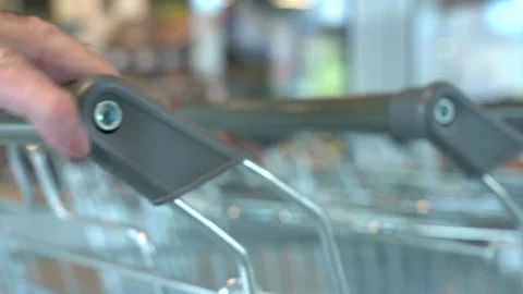 The customer takes a trolley from the row Video stock 153964823