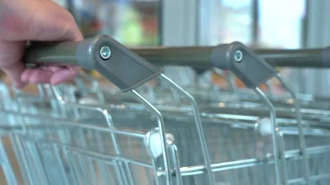 The customer takes a trolley from the row Stock Footage 166053054