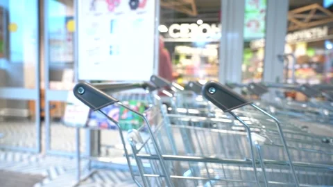 The customer takes a trolley from the row Stock Footage 166996797