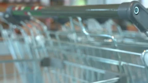 The customer takes a trolley from the row Stock Footage 167551335