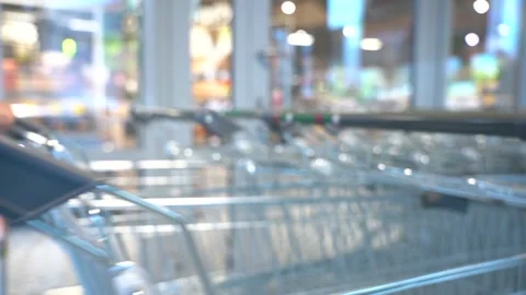 The customer takes a trolley from the row Stock Footage 167551754