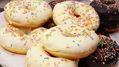 Customer taking glazed donut from bakery display in supermarket Stock Footage 336663518