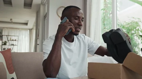 Customer Talking to Support Service about Wrong Shoes in Parcel Stock Footage 281711734