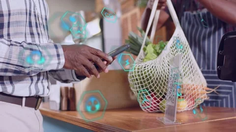 Customer tapping phone, starting mobile pay, teal UI animating around phone as Stock Footage 333034735
