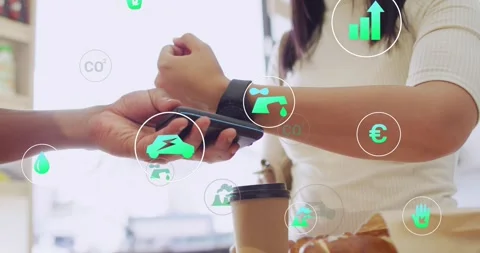 Customer tapping watch after staff holding POS at cafe paying while eco icons Stock Footage 321453556