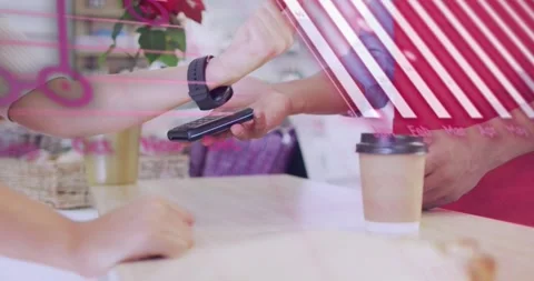 Customer tapping watch paying in cafe staff holding POS steadying cup pink Stock Footage 321347047