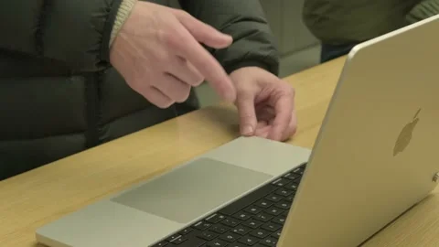 Customer testing new Macbook tablet in apple sales office in Germany, produ.. Stock Footage 236585035