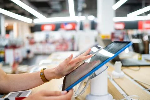 Customer testing tablet at retail store Stock Photos