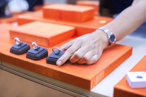 Customer Touching Diamond Ring Displayed on Showcase Counter in Jewelry Store Stock Photos