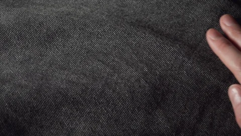 Customer touching a smooth black jeans, checking the quality of fabric in a Stock Footage 122594798