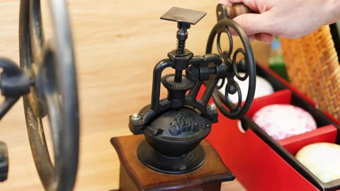 Customer tries out hand crank coffee grinder. Stock Footage 305371009