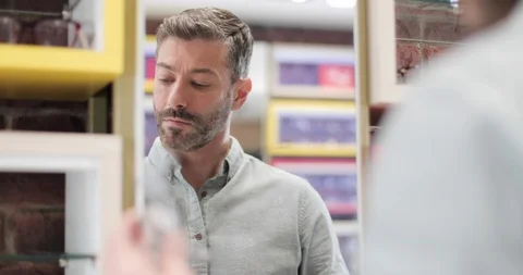 Customer trying frames at the optician 스톡 동영상 105416000