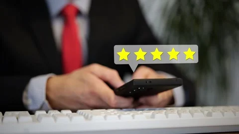Customer typing on a smartphone with a digital overlay of five rating stars Stock Footage 336342643