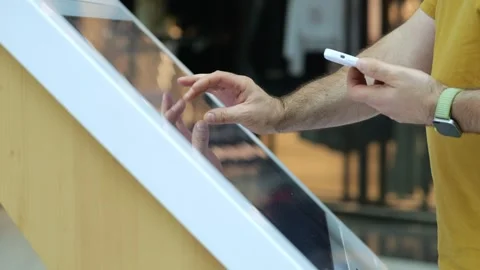 Customer uses digital kiosk with stylus in hand Stock Footage 345677822