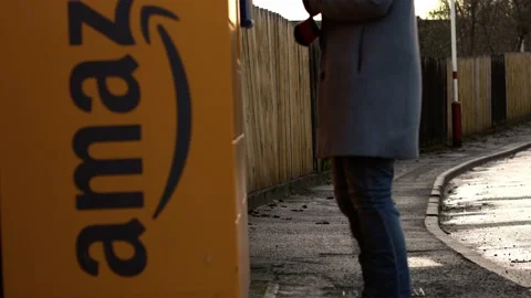 Customer using Amazon collection locker point in street Video stock 230485874