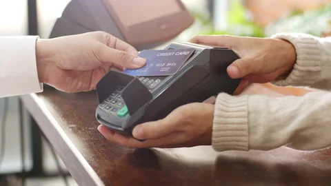 Customer using credit card for payment to owner at cafe restaurant Stock Footage 146926341
