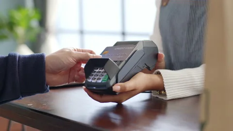 Customer using credit card for payment to owner at cafe restaurant, cashless Stock Footage 147523646