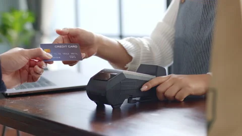 Customer using credit card for payment to owner at cafe restaurant, cashless Stock Footage 147525279