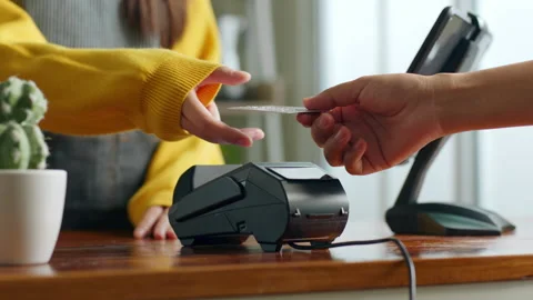 Customer using credit card for payment to owner at cafe restaurant Stock Footage 196901252
