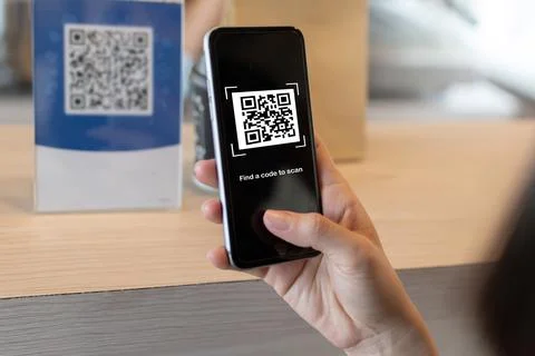 Customer using digital mobile phone scan QR code pay for buying coffee Stock Photos