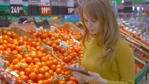 Customer Using Digital Tablet While Shopping In Grocery Store Stock Footage 75403838