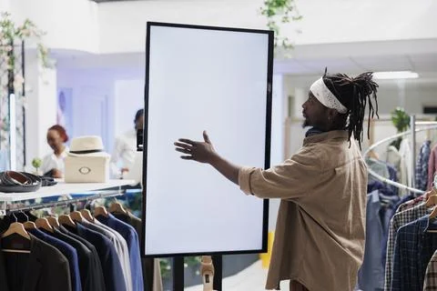 Customer using empty white smart screen to browse clothes 스톡 사진
