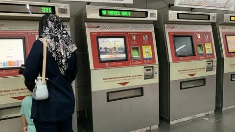 Customer is using LRT train ticket machine at puchong jaya station.selangor.. Stock Photos