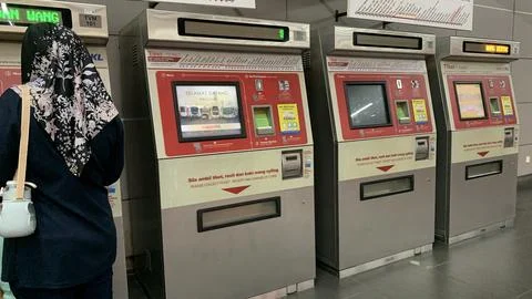 Customer is using LRT train ticket machine at puchong jaya station Stock Photos