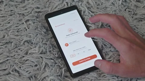 Customer using online food delivery application on mobile phone screen to leave Stock Footage 341569546
