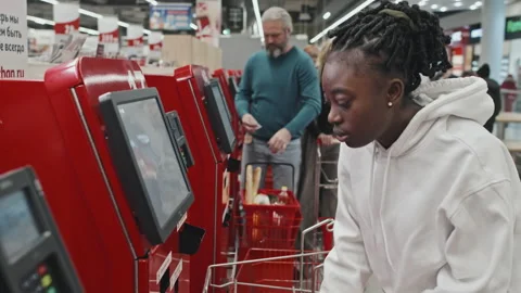 Customer Using Self Checkout Service in Supermarket Stock Footage 224063793