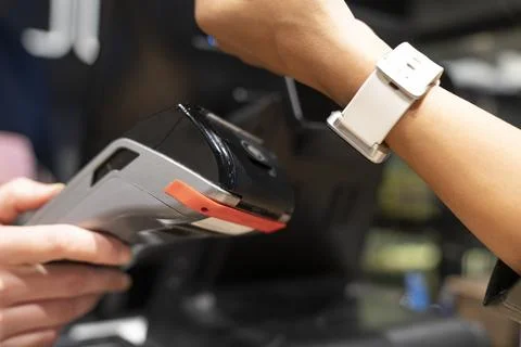 Customer Using Smart Watch For Contactless Payment Stock Photos