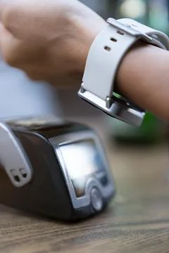 Customer Using Smart Watch For Contactless Payment Stock Photos