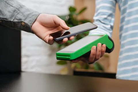 Customer using smartphone for contactless payment Stock Photos