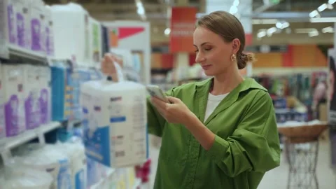 Customer using smartphone scanning product in supermarket Stock Footage 285026370