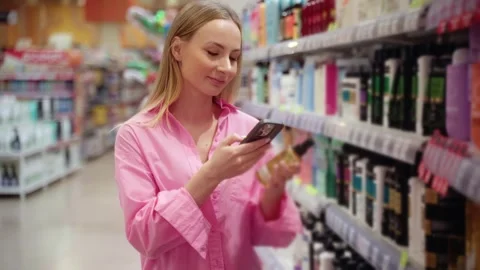 Customer using smartphone scanning product barcode in supermarket Stock-Footage 311983777