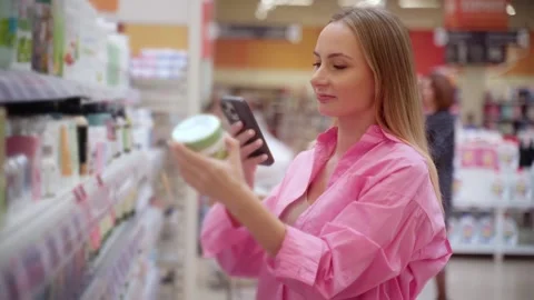 Customer using smartphone scanning products in supermarket Stock Footage 311983995