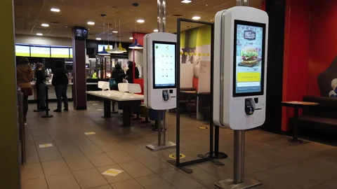 Customers and delivery drivers inside a McDonald's restaurant in Reading, UK Stock Footage 146004225