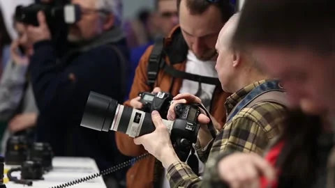 Customers are testing the Nikon camera and lenses Stock Footage 88561475