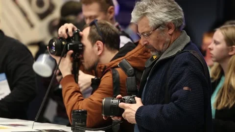 Customers are testing the Nikon camera and lenses Stock Footage 88561493