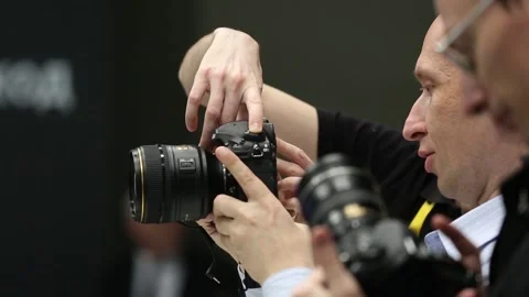 Customers are testing the Nikon camera and lenses Stock Footage 88561543