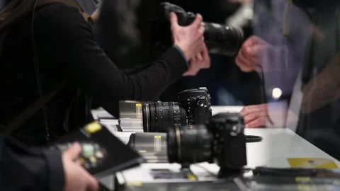 Customers are testing the Nikon camera and lenses Stock Footage 88561550