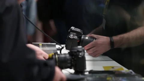 Customers are testing the Nikon camera and lenses Stock Footage 88561558