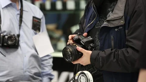 Customers are testing the Nikon camera and lenses Stock Footage 88561566
