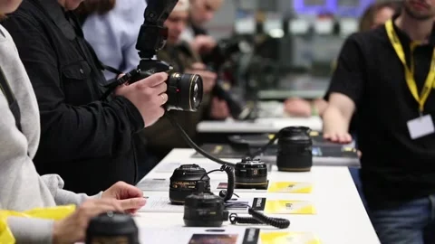 Customers are testing the Nikon camera and lenses Stock Footage 88561633
