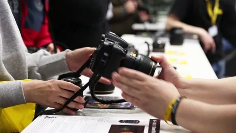 Customers are testing the Nikon camera and lenses Stock Footage 90104327