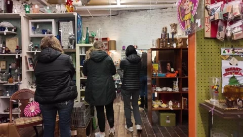 Customers browse through a vintage store filled with eclectic items. Stock Footage 333917544