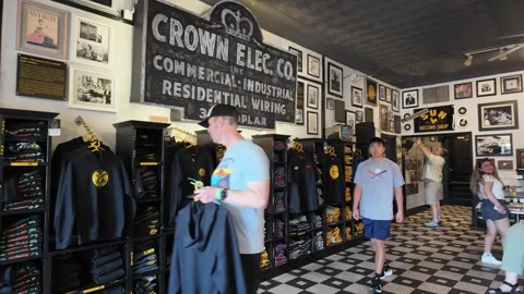 Customers browsing merchandise inside a vintage record store Stock Footage 336351904