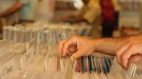 Customers browsing through vintage records in records store Stockbeeldmateriaal 40634633